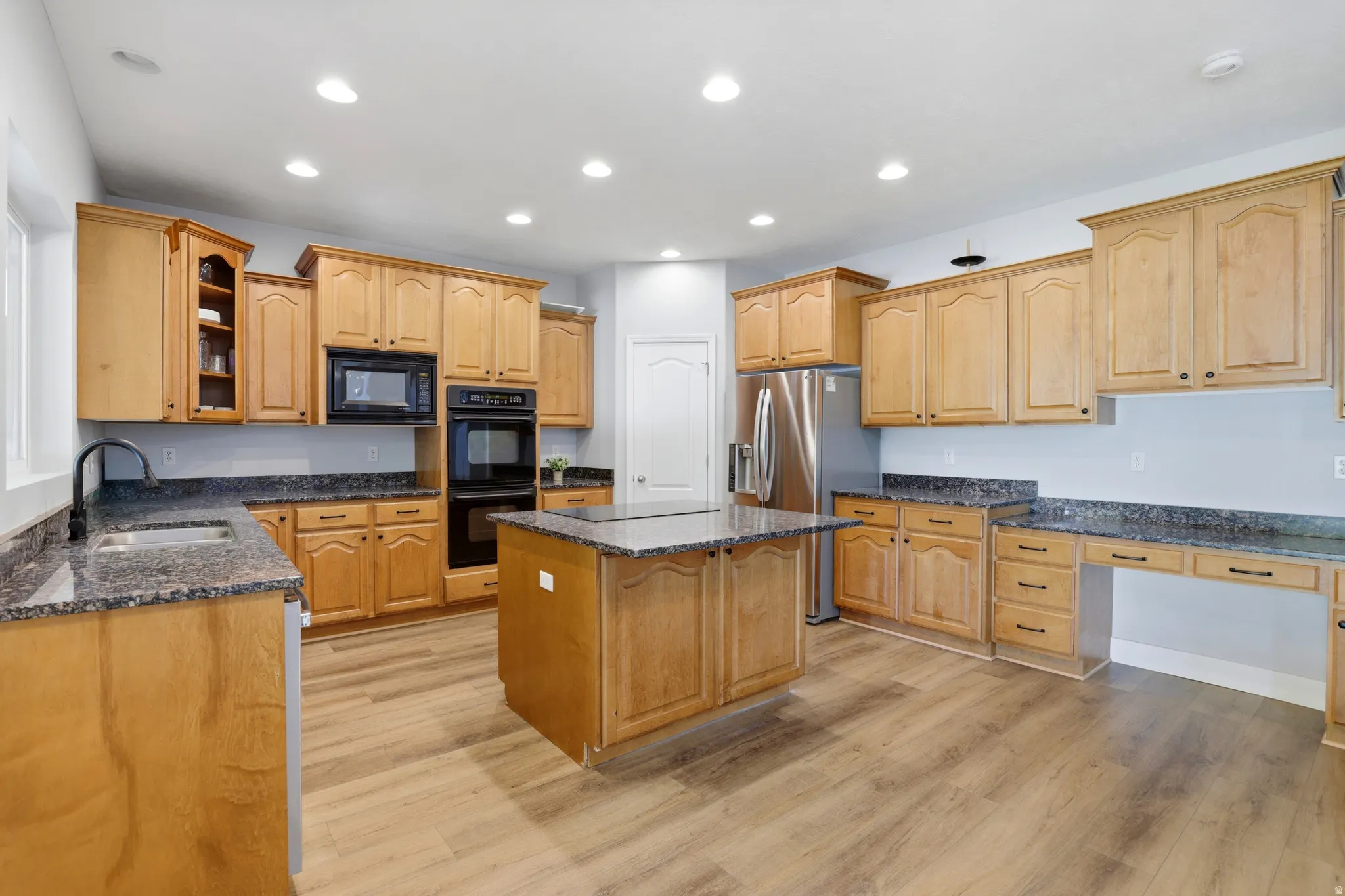 Kitchen featuring wood-finish flooring and recessed lighting
