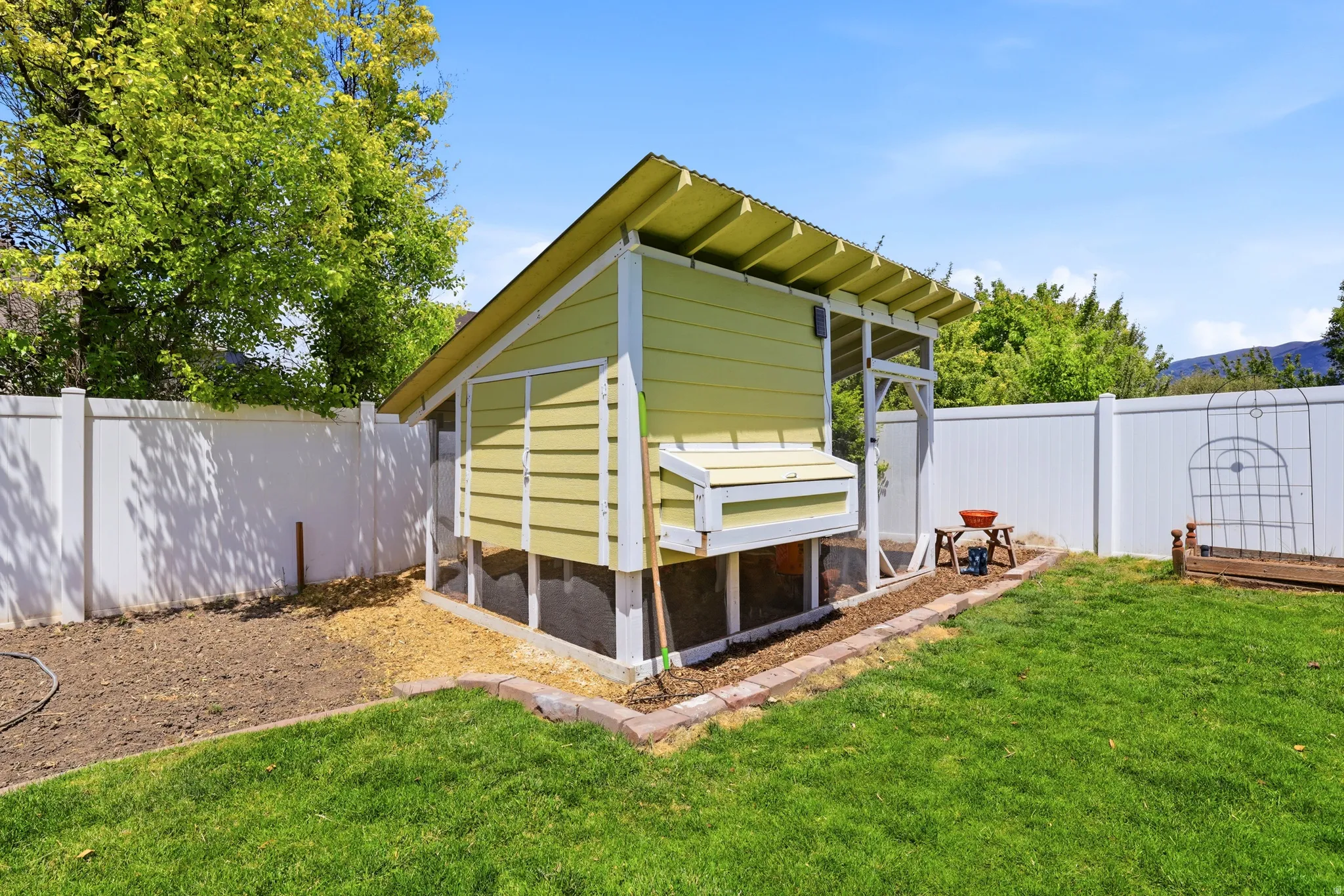 Custom-built outdoor structure featuring light green siding and white trim