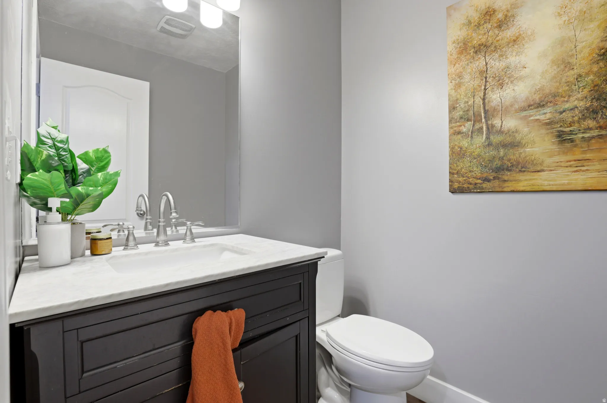Vanity with an integrated white sink, brushed nickel faucet, and light-colored countertop