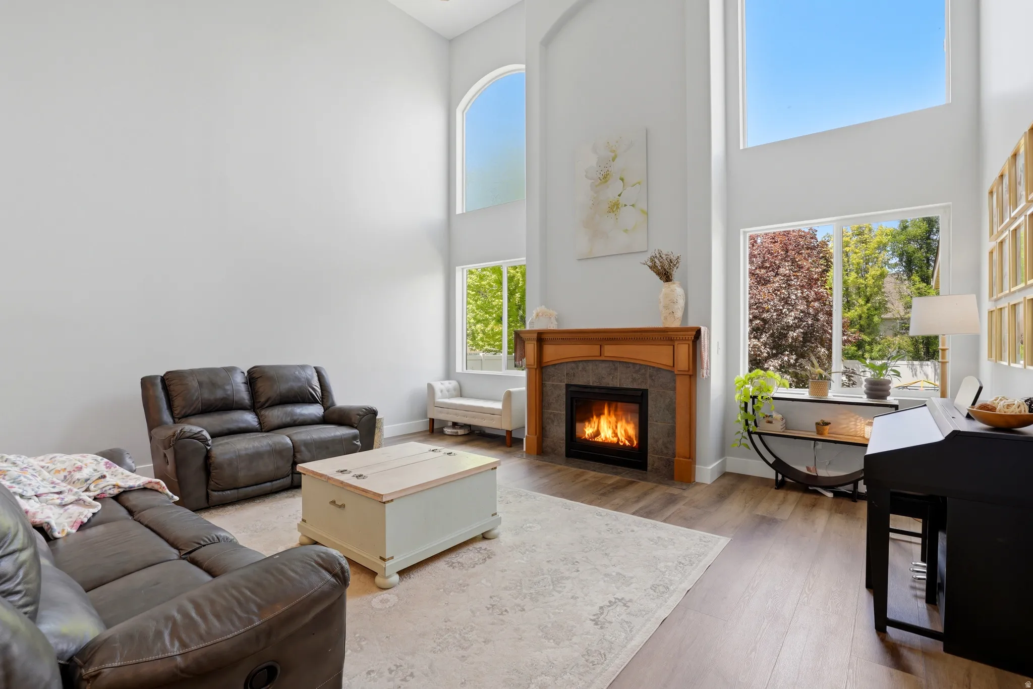 Living area featuring soaring ceilings and wood-finish flooring
