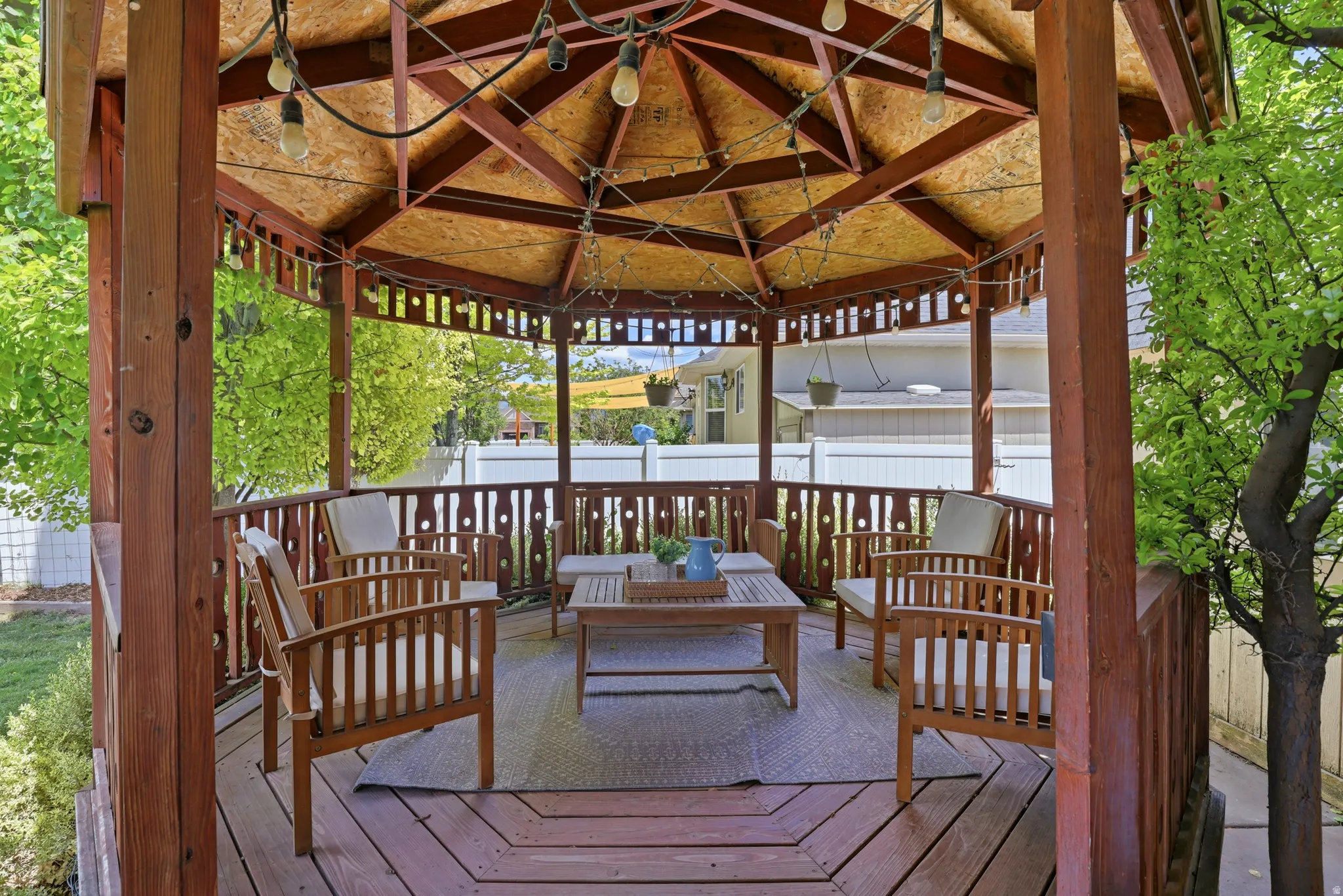 Expansive hexagonal gazebo featuring a wood-finish deck and a slatted wood ceiling