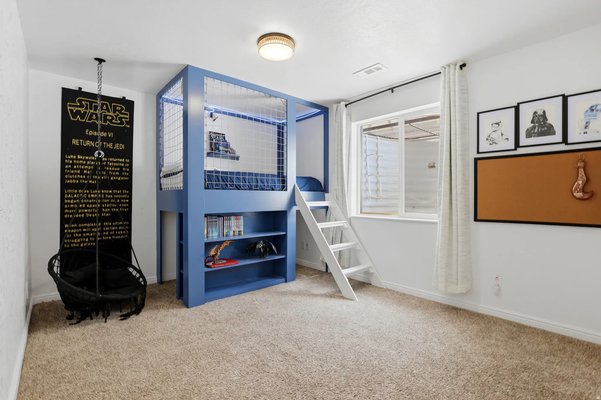 Room featuring a built-in blue loft bed with integrated shelving and a white ladder