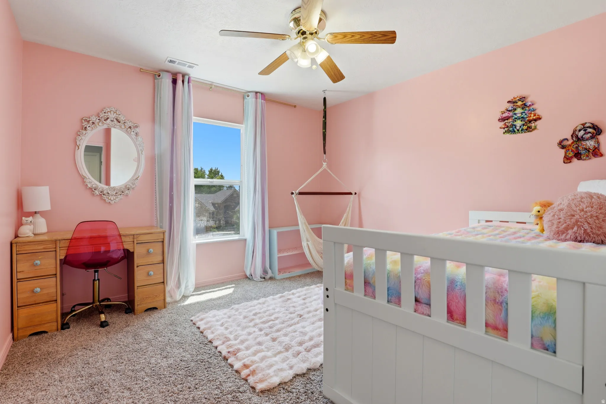 Spacious room with a ceiling fan, window with curtains, and gray carpet