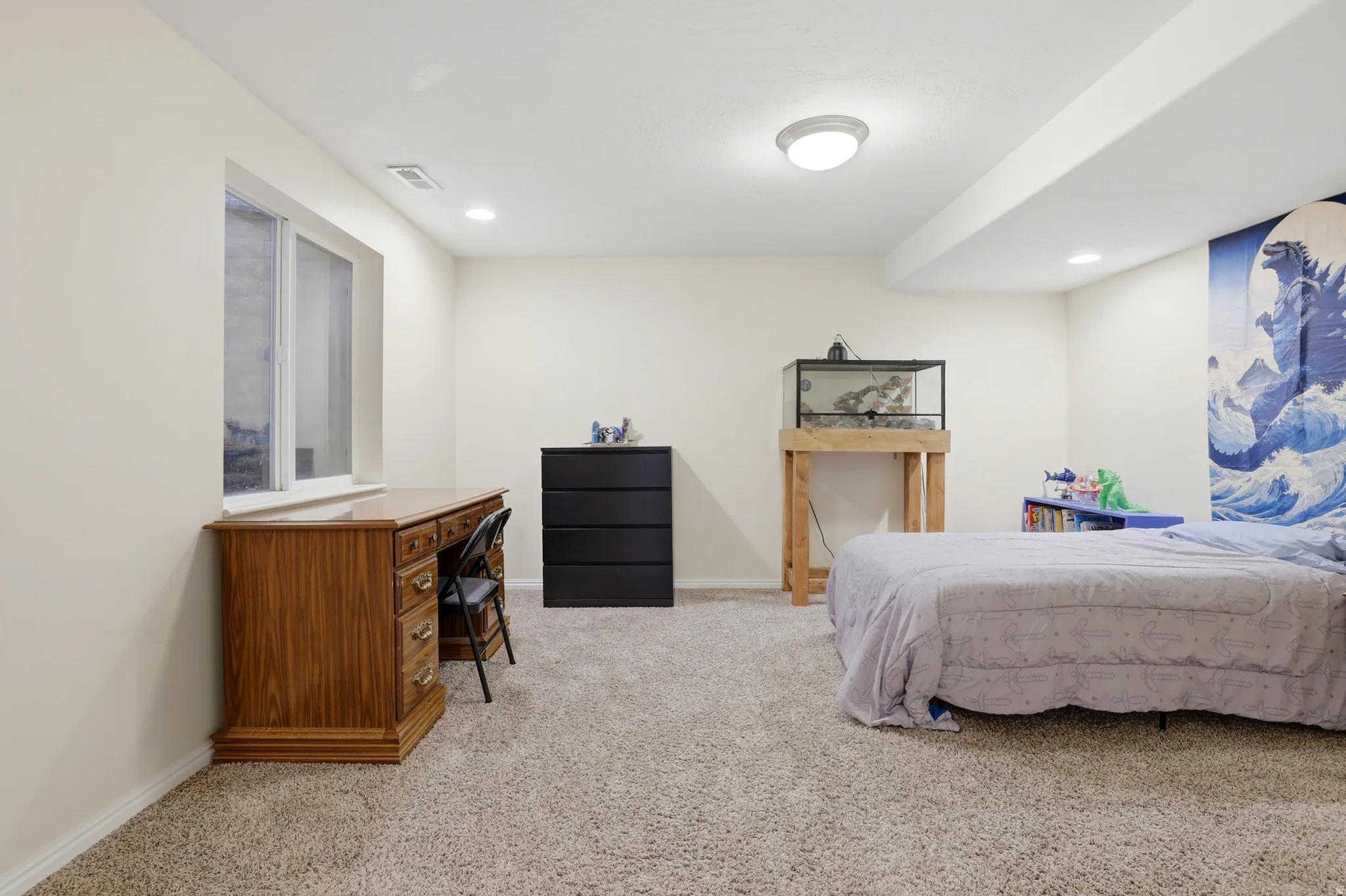 Spacious room with plush carpet, neutral wall tones, and recessed lighting