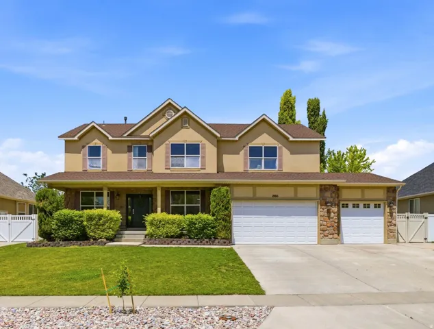 Stucco exterior home with stone accents and a covered front porch