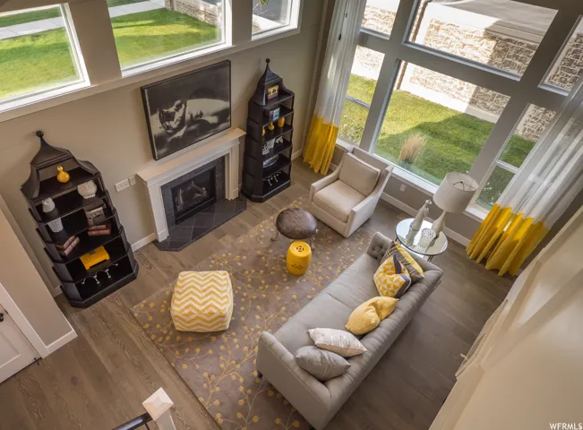 Living room featuring a tile fireplace and wood finished floors