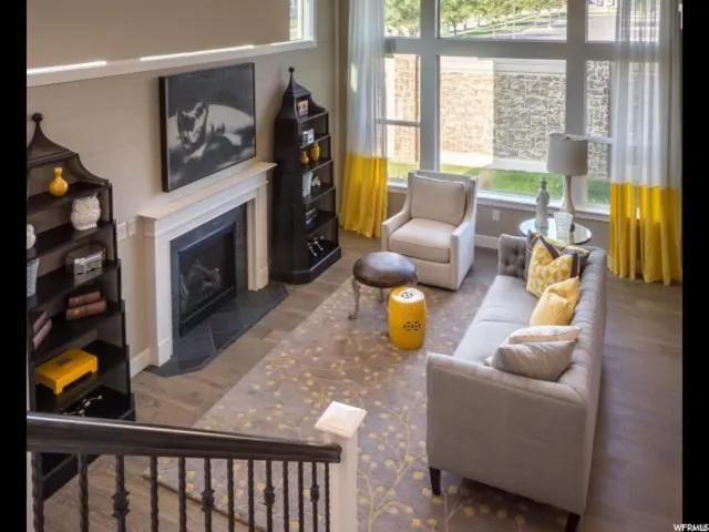 Living area featuring a fireplace with flush hearth and wood finished floors