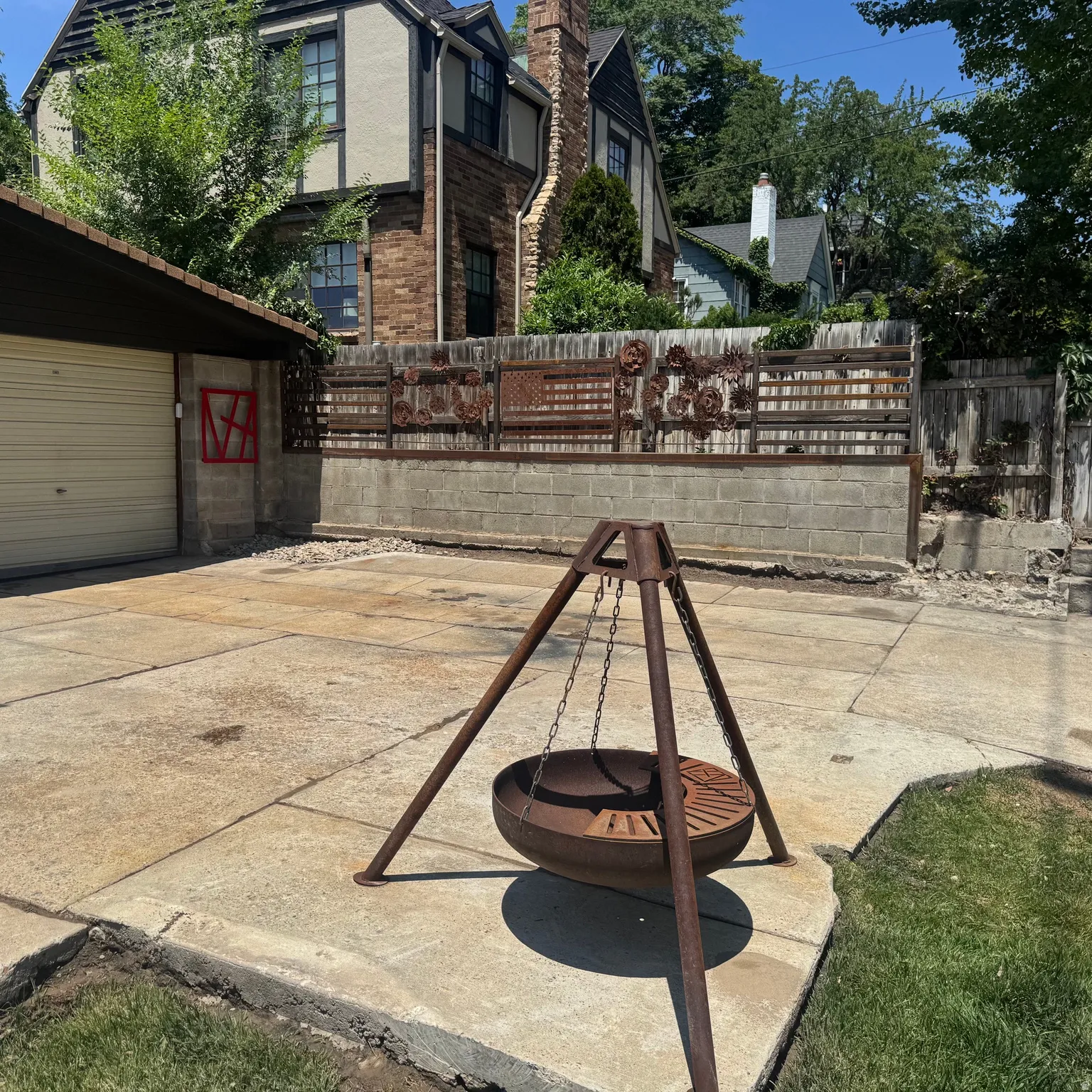 Concrete patio area with a unique metal fire pit