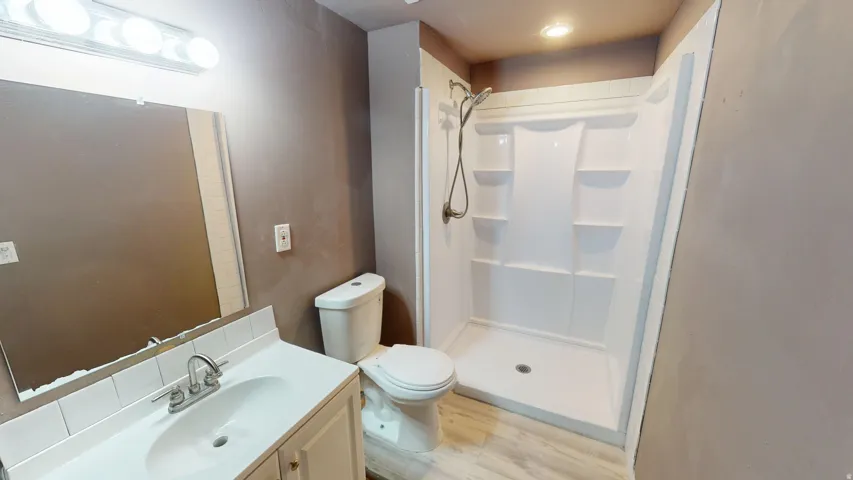 White vanity with integrated sink, chrome faucet, and tile backsplash