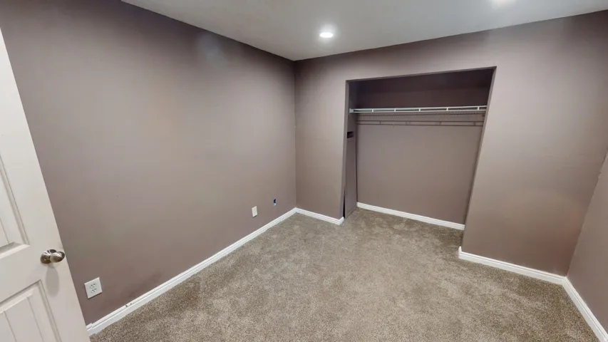 Neutral-toned walls complement plush carpeting