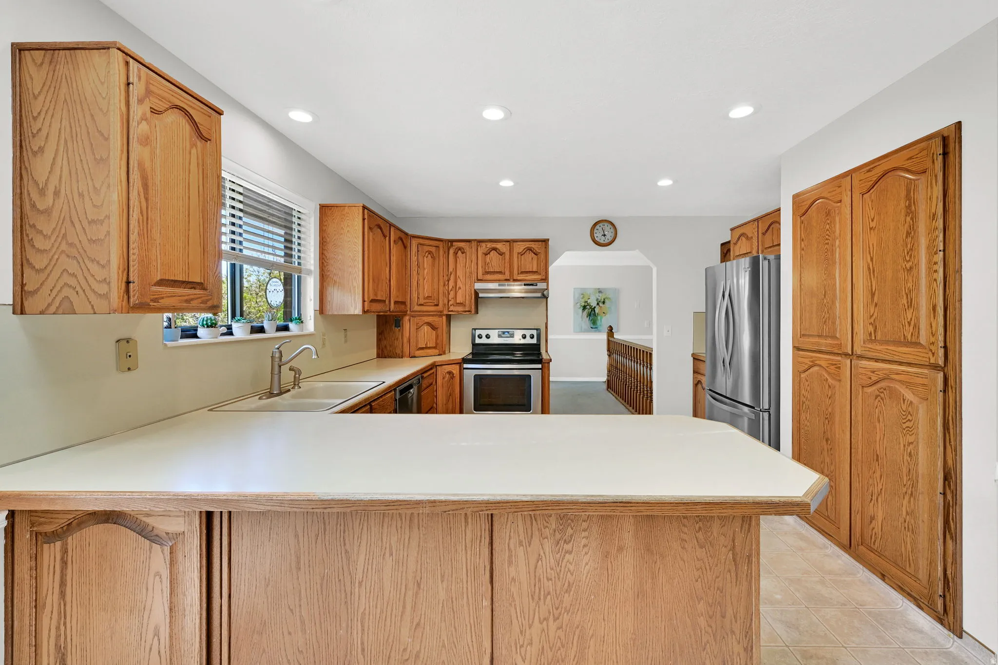 Kitchen featuring light wood cabinetry and light countertops