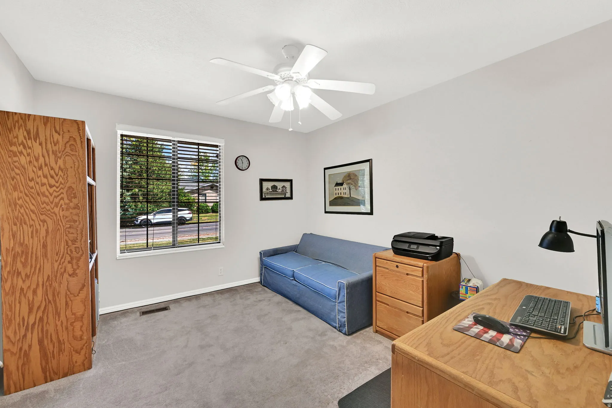 Bedroom #3 featuring light gray walls, gray carpet, and a white ceiling fan