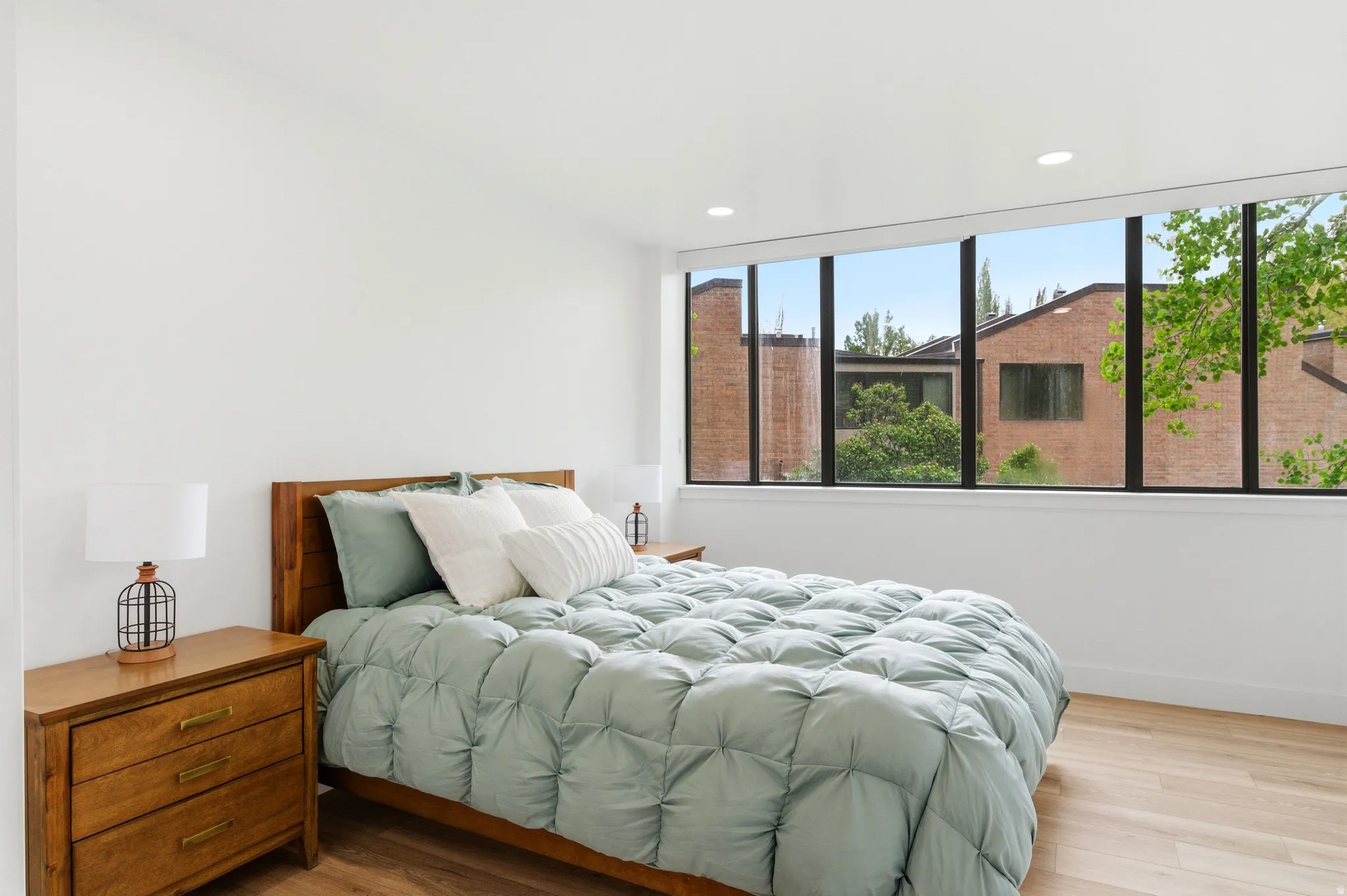 Light wood-finish flooring complements the crisp white walls