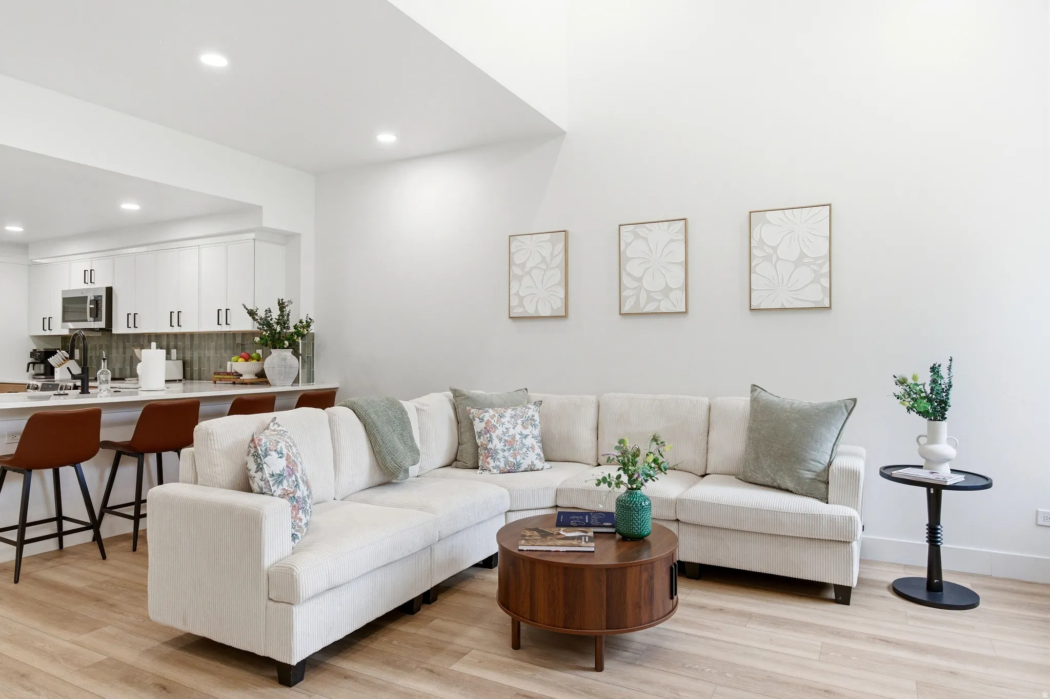 Open-concept living area featuring light wood-finish flooring and recessed lighting
