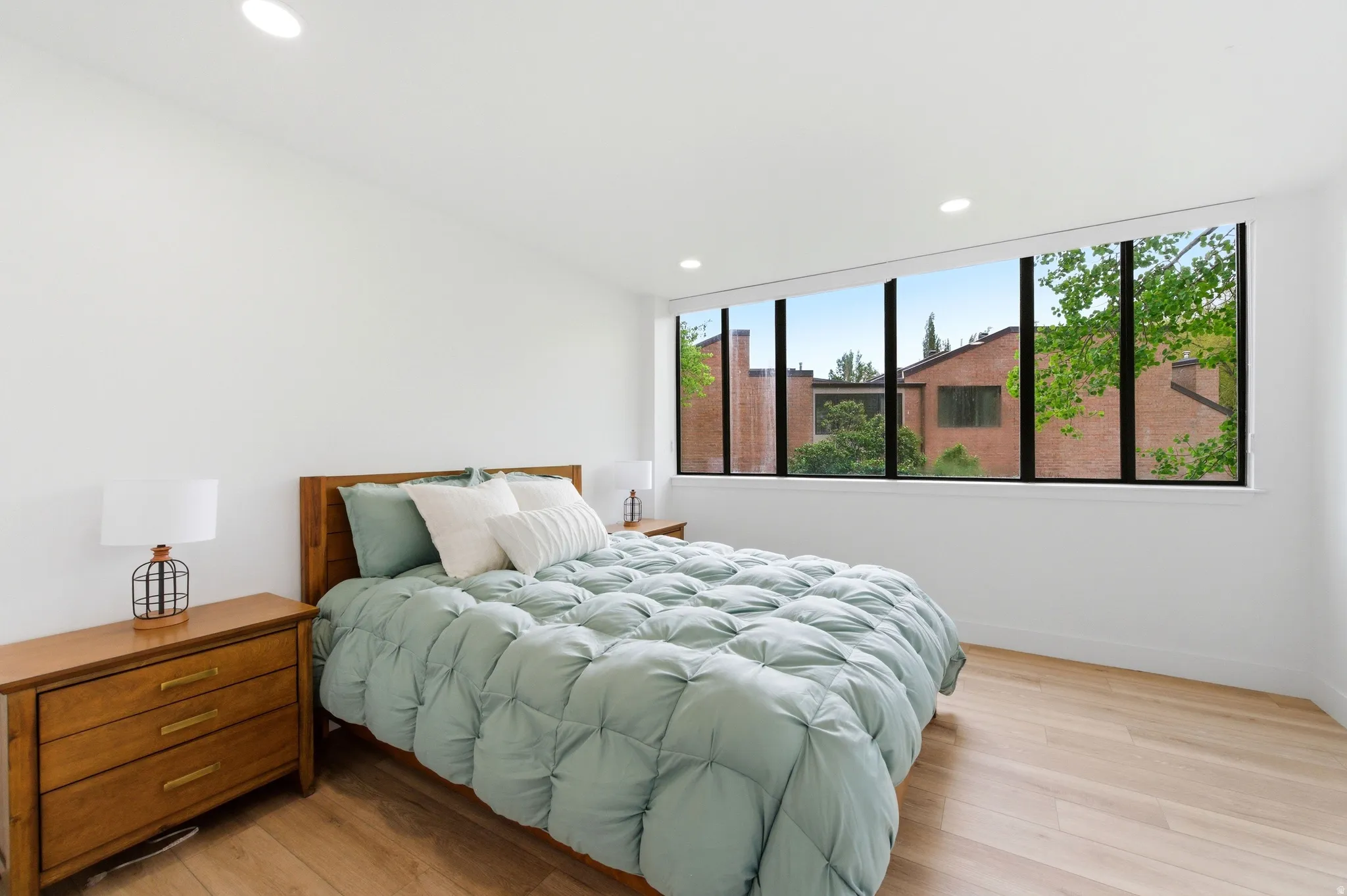 Bright room featuring a wide picture window with dark framing