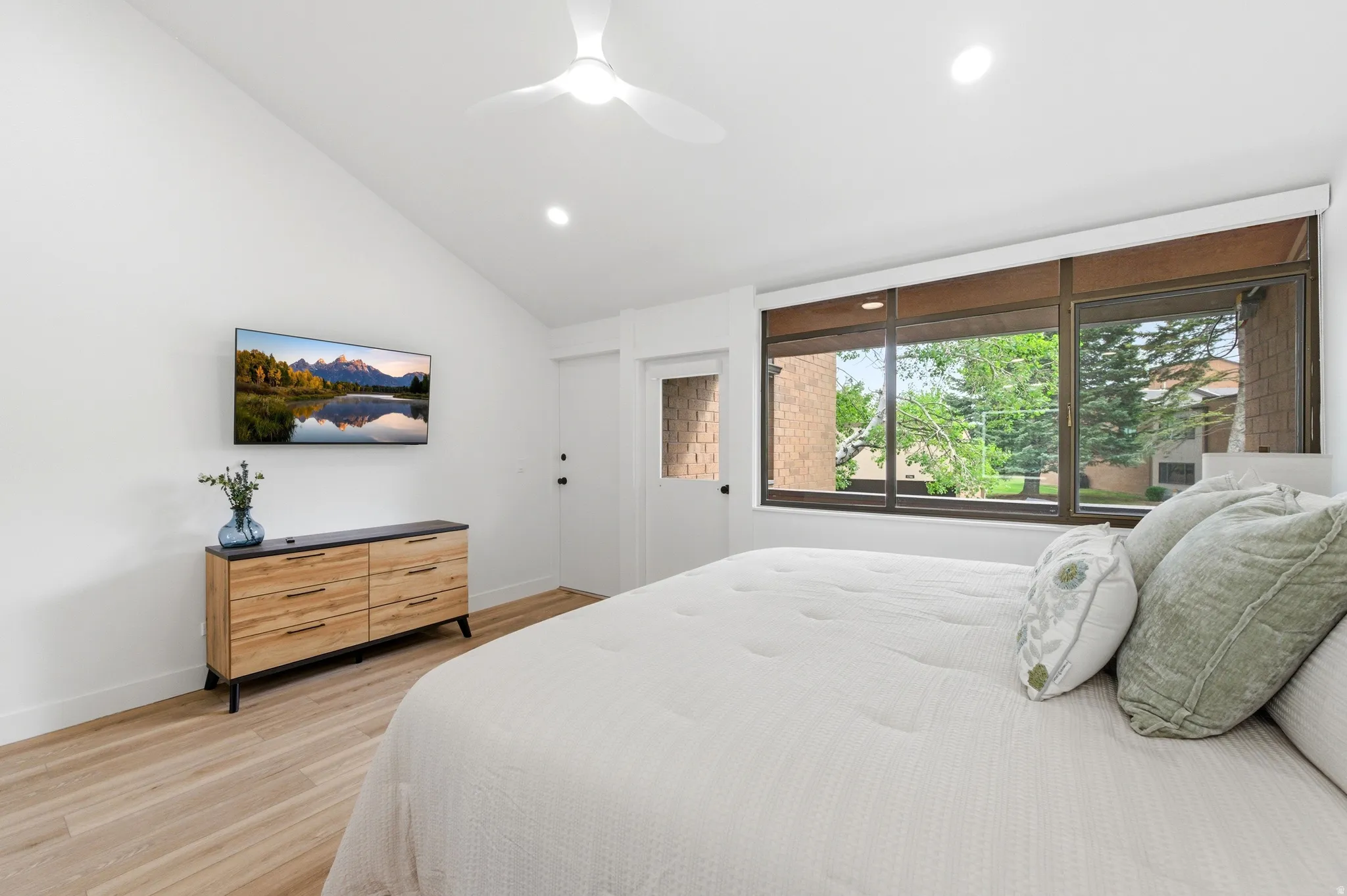 Bedroom featuring a vaulted ceiling with a ceiling fan, recessed lighting, and wood-finish flooring