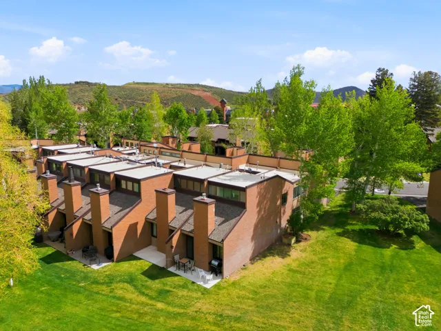 Distinctive architectural residence featuring bold terracotta brick construction with geometric facades and expansive roofline