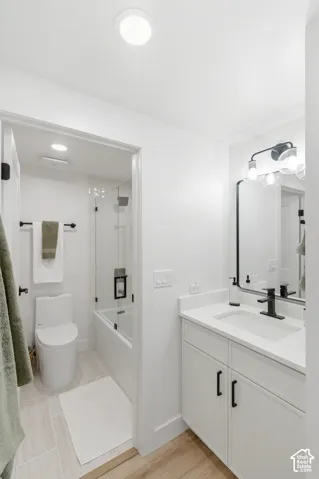 Modern bathroom featuring a spacious walk-in shower with frameless glass enclosure, white subway tile surround, and rainfall showerhead
