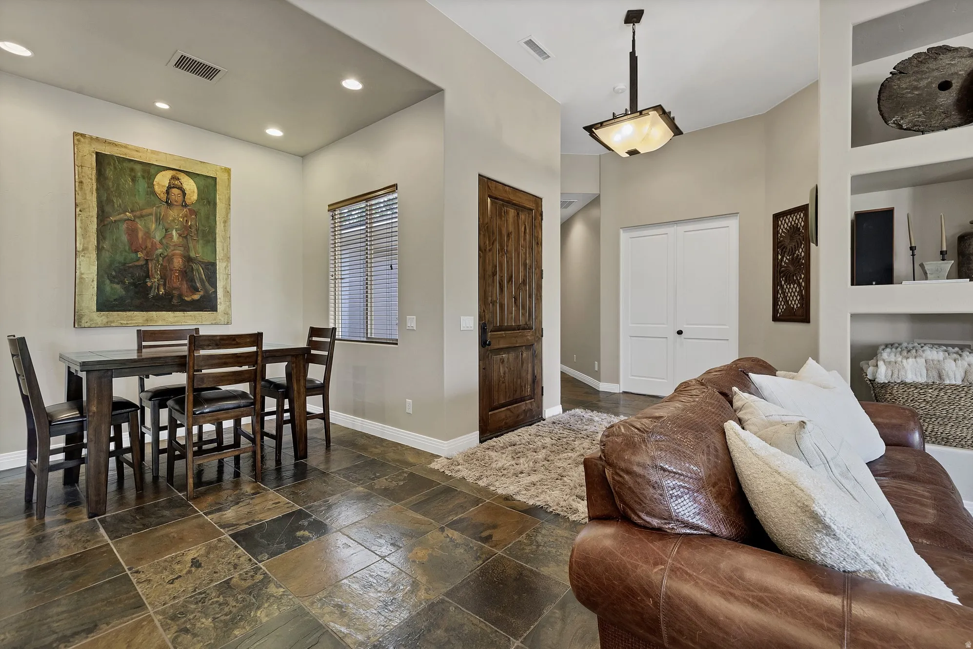 Slate-style tile flooring extending into the hallway