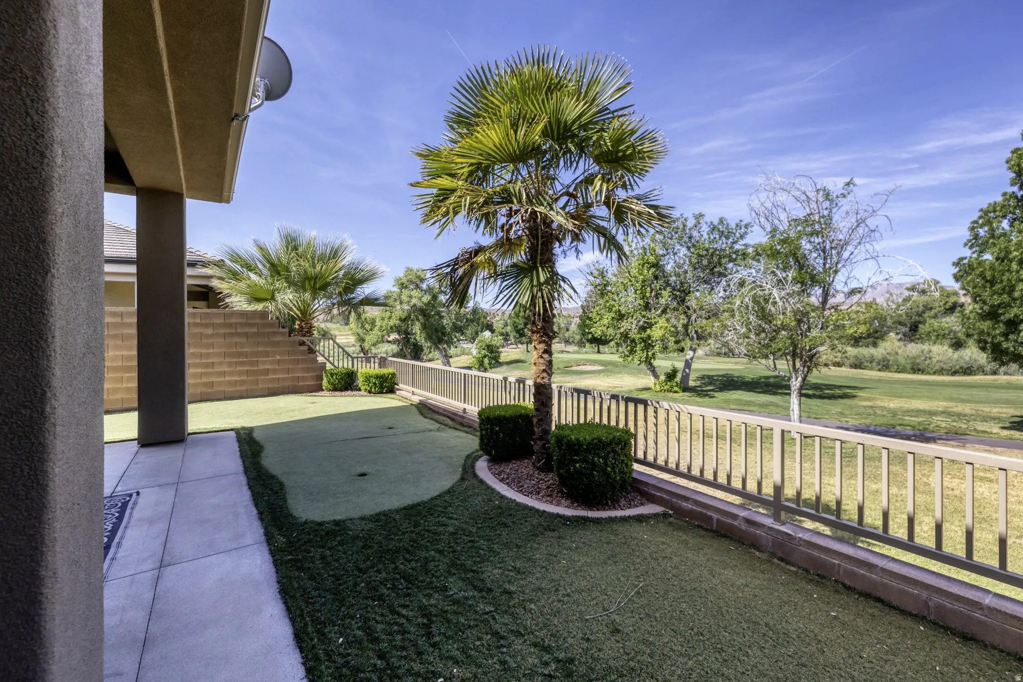 Exterior patio with concrete slab flooring and stucco support columns