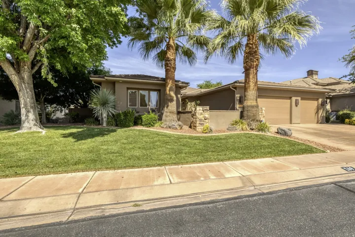 Stucco exterior with a tile roof and integrated garage