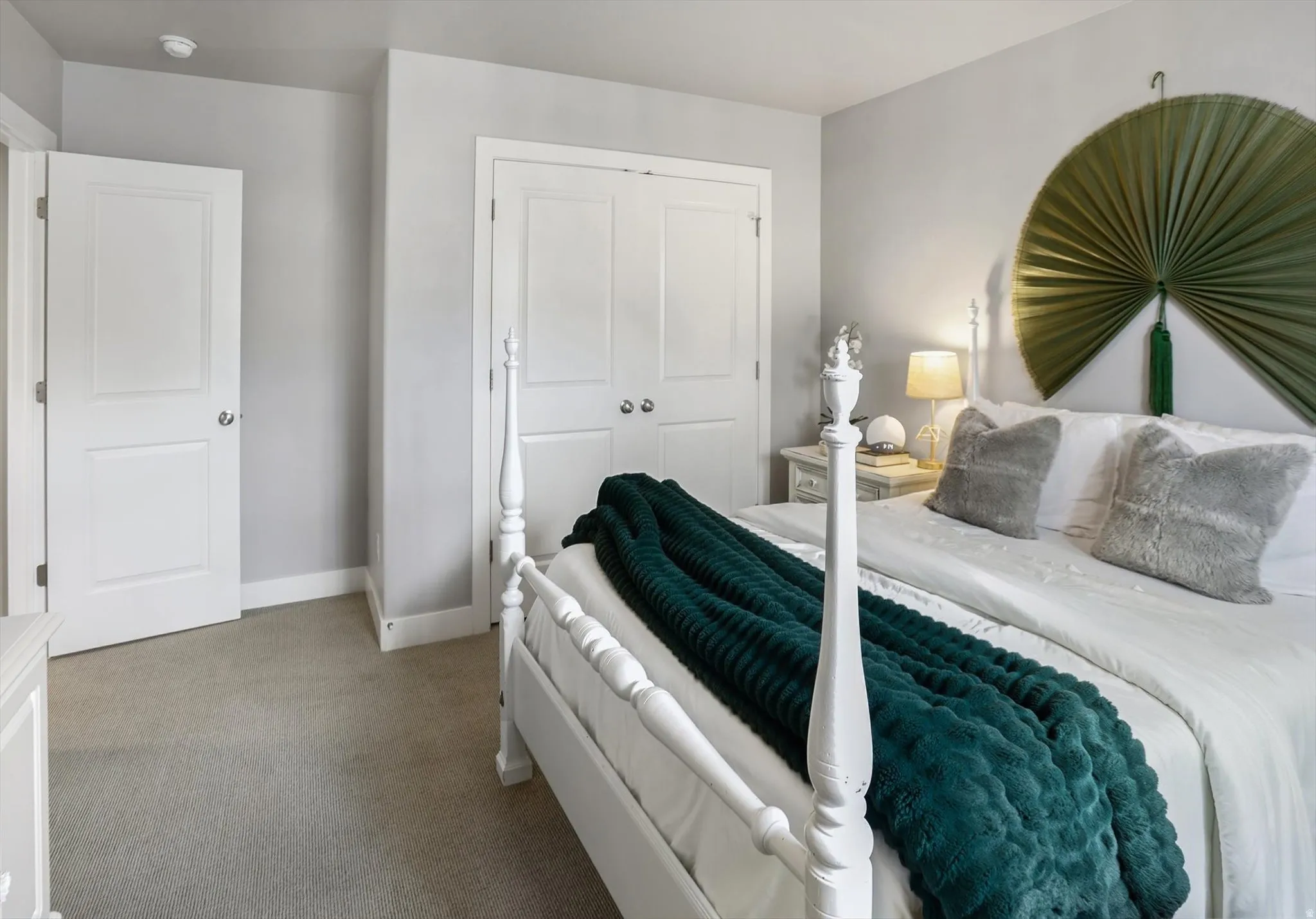 Bedroom #5 featuring light gray wall paint, light-colored carpet flooring, and white baseboards