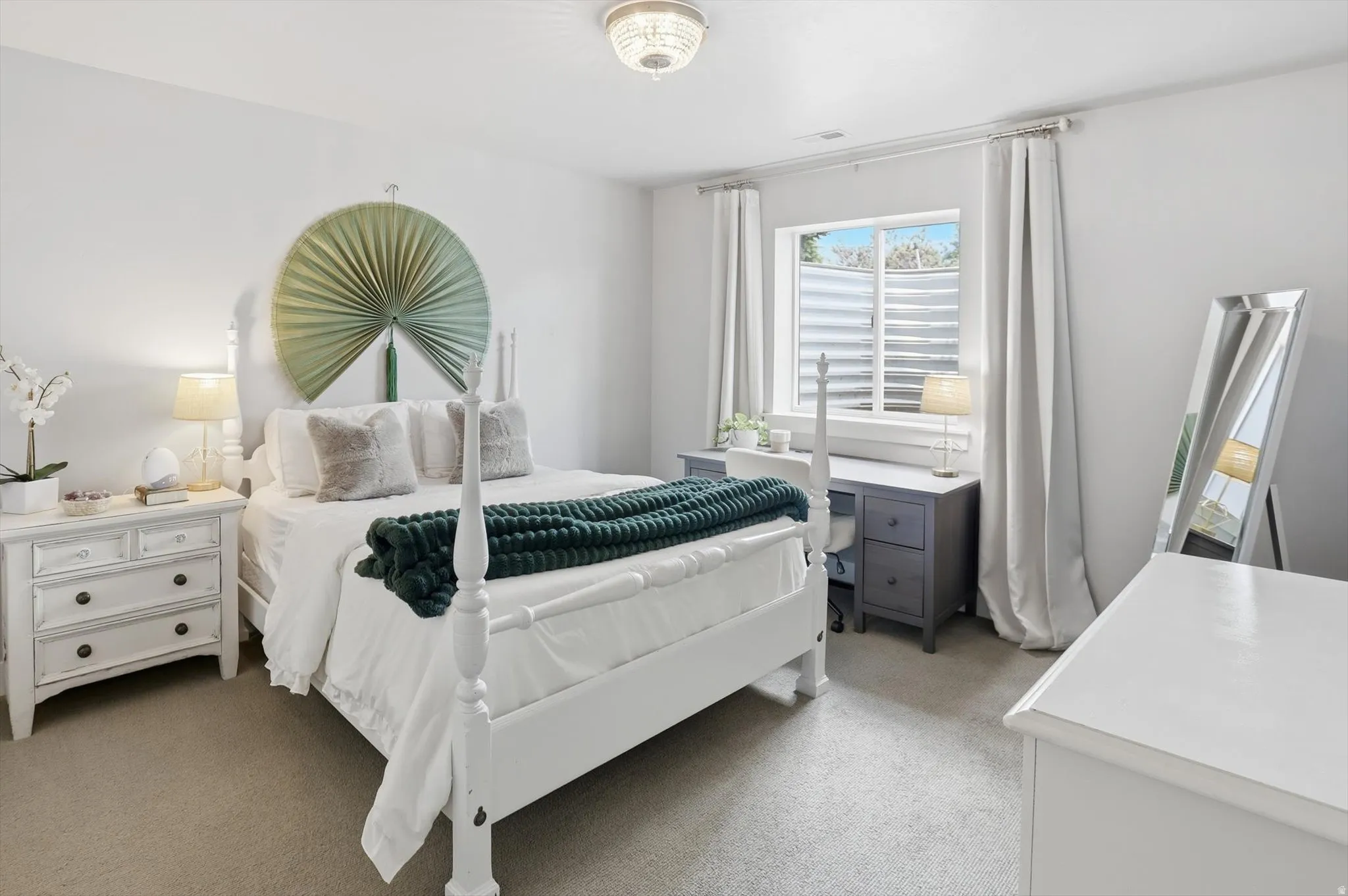 Bedroom #5 Carpeted room featuring a ceiling-mounted light fixture, white walls, and a window with a window well