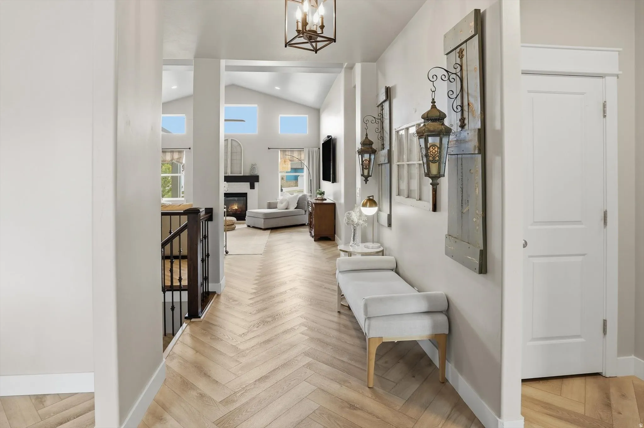 Herringbone wood-finish flooring extending through a brightly lit hallway