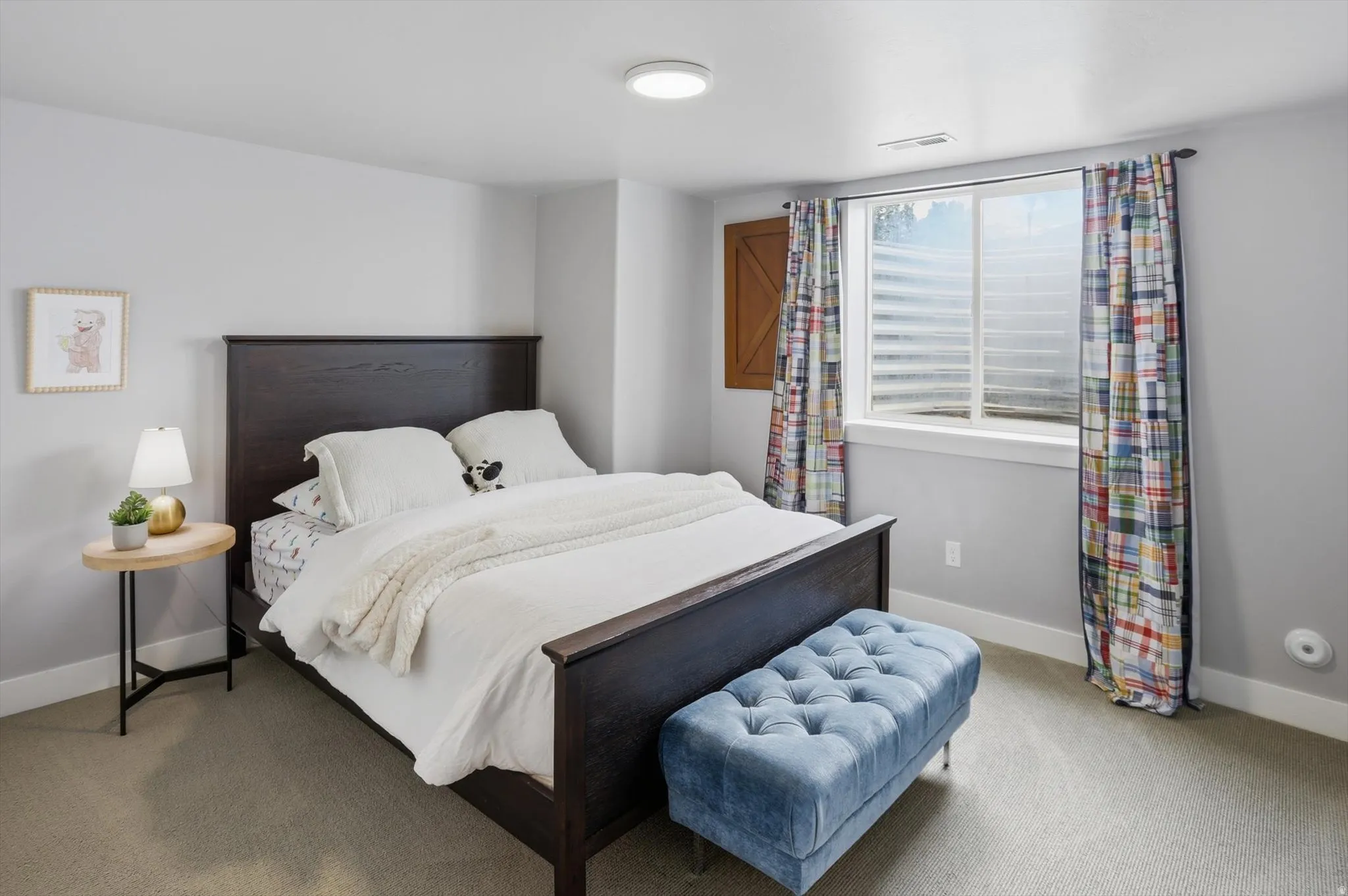 Bedroom #4 Carpeted room featuring a light gray wall color, a white ceiling with a flush-mount circular light fixture, and a window with white trim