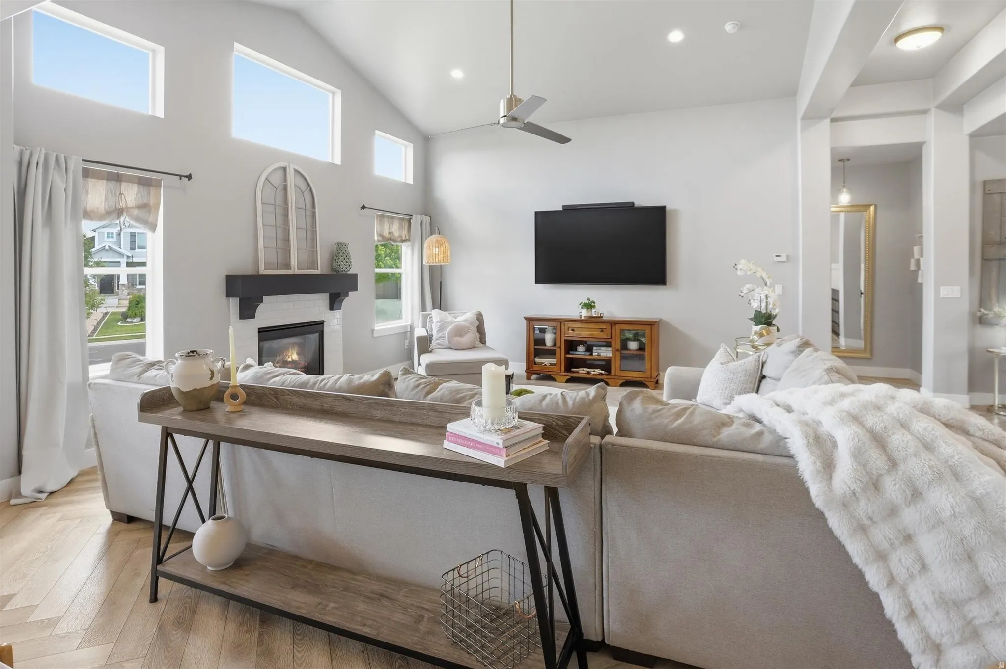 Living area with vaulted ceilings and wood-finish flooring