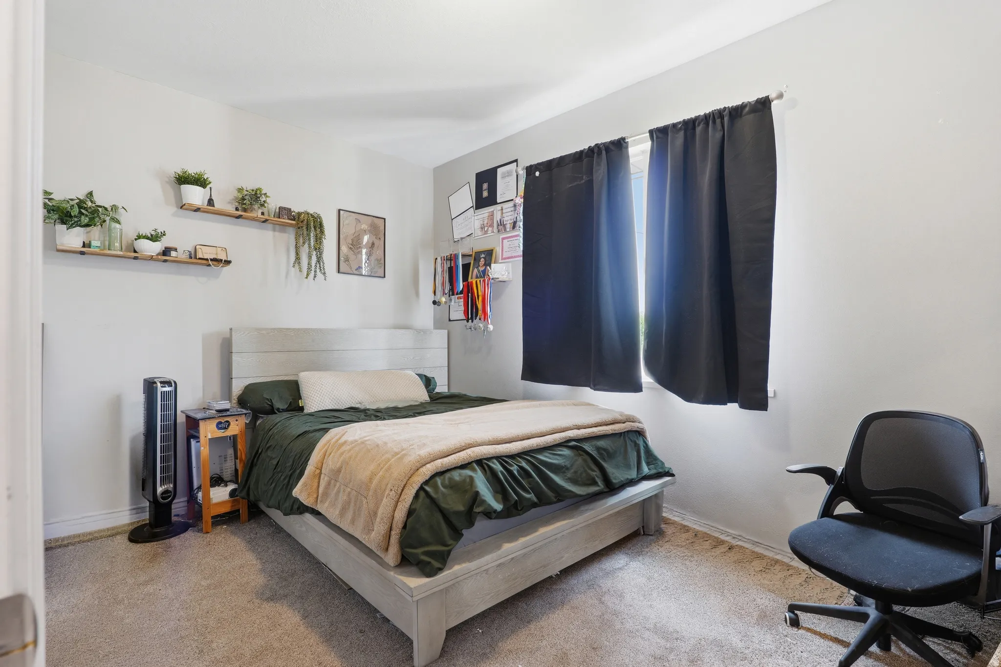 Neutral wall tones complement the carpeted flooring