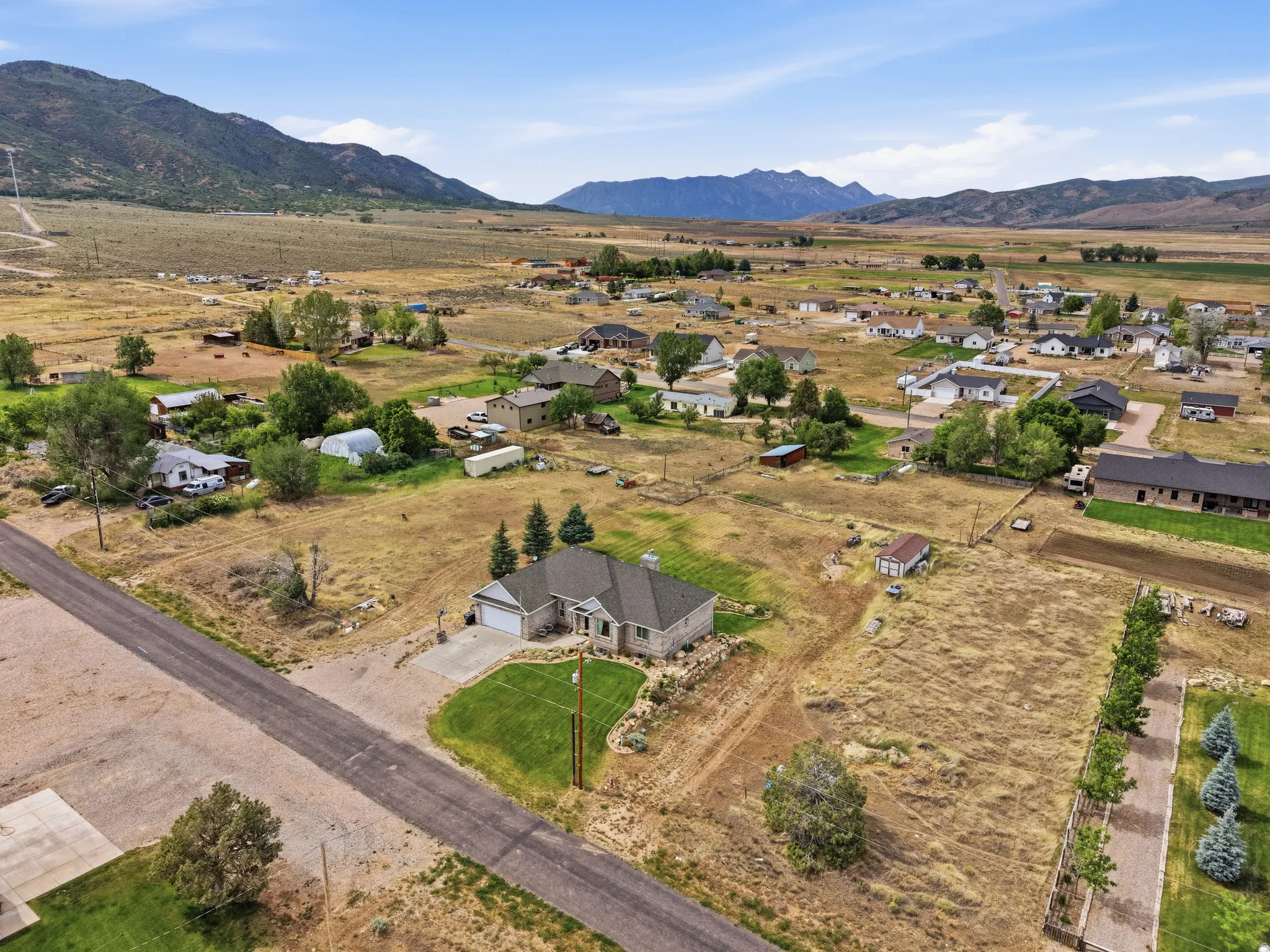 Ranch-style residence featuring a stone and siding exterior, an attached two-car garage, and a manicured front lawn