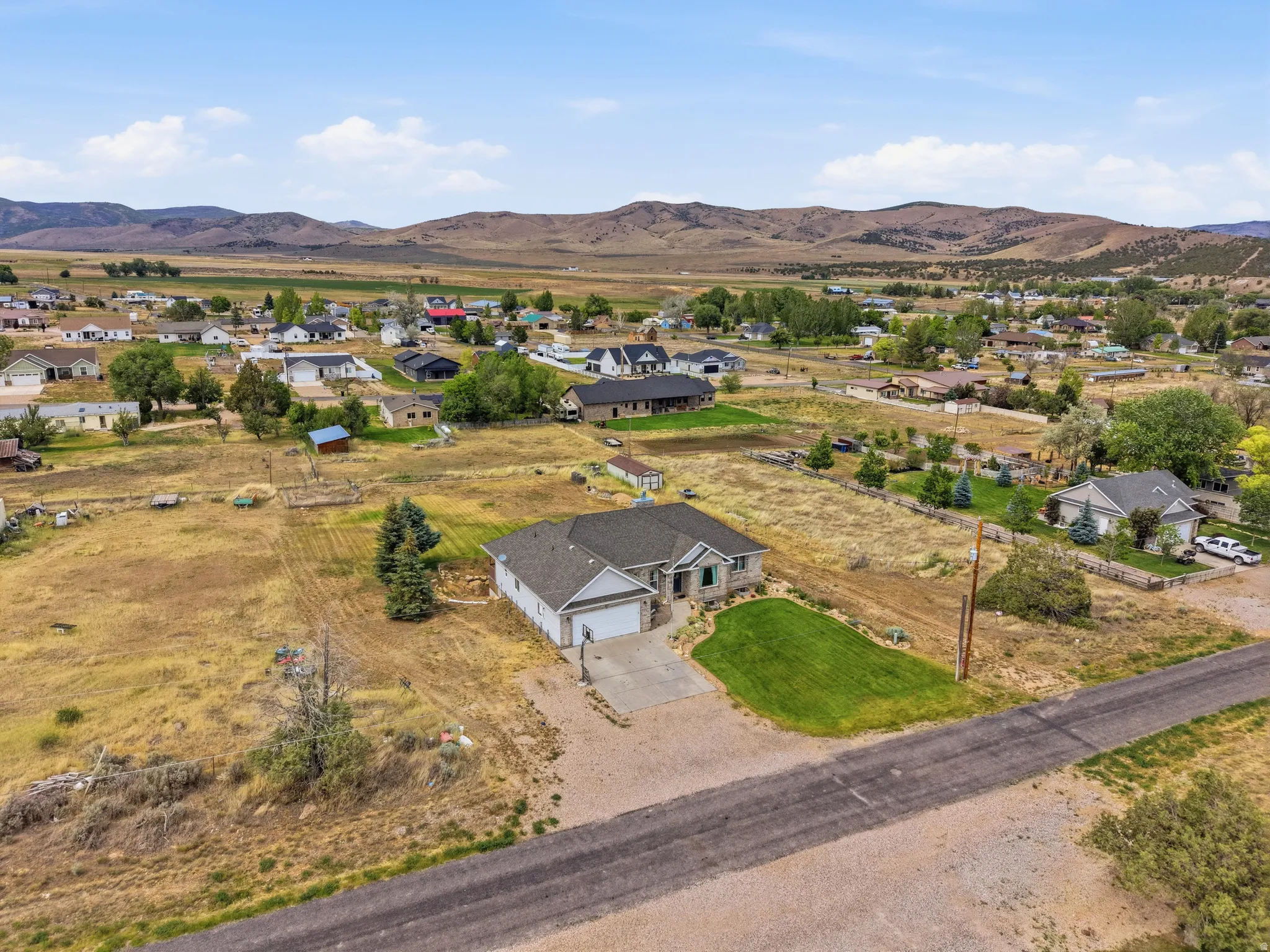 Ranch-style residence featuring a stone and siding exterior, an attached two-car garage, and a concrete driveway