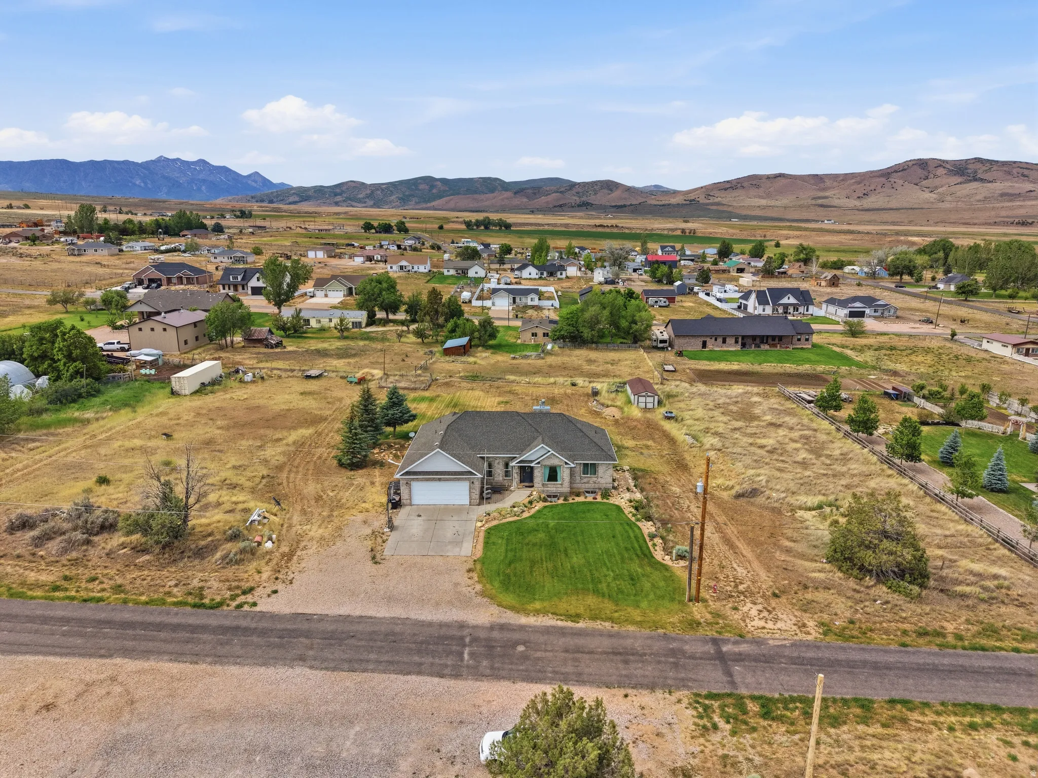 Ranch-style residence featuring a stone and siding exterior, an attached two-car garage, and a manicured front lawn