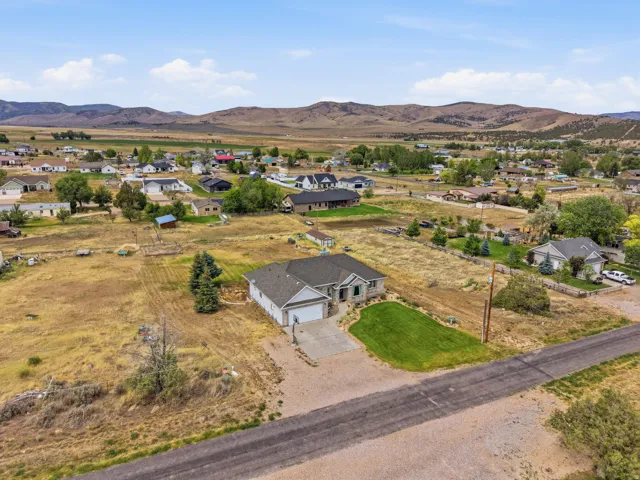 Ranch-style residence featuring a stone and siding exterior, an attached two-car garage, and a concrete driveway