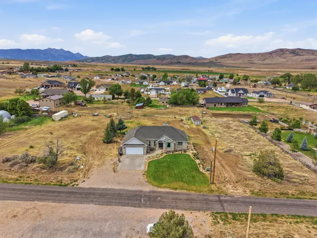 Ranch-style residence featuring a stone and siding exterior, an attached two-car garage, and a manicured front lawn