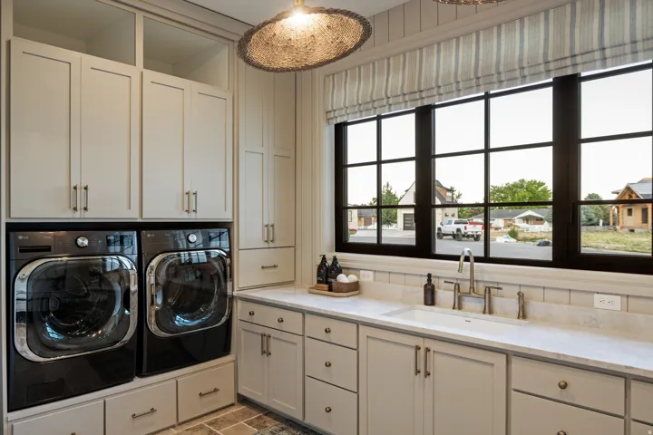 Laundry area with separate washer and dryer and cabinet space