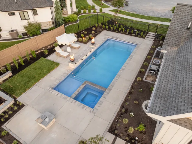 Relaxing pool / spa featuring a patio and a fenced backyard