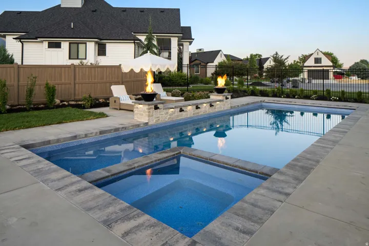 Integrated pool / spa featuring a patio area and a residential view