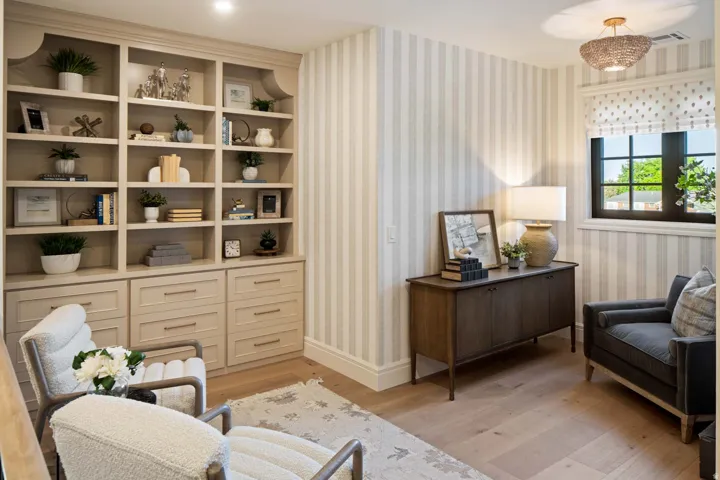Sitting room with light wood-type flooring and wallpapered walls
