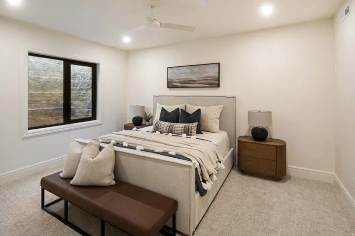 Bedroom featuring light carpet, ceiling fan, and recessed lighting