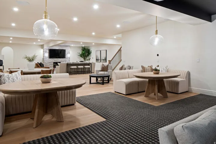 Dining room with light wood-style floors, recessed lighting, and arched walkways