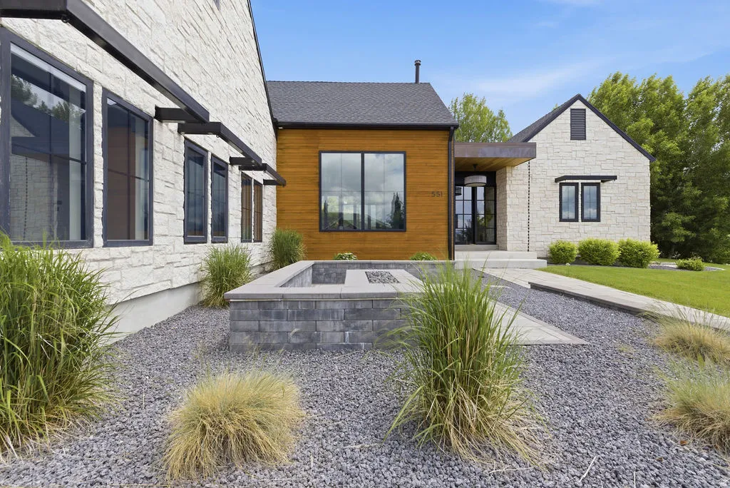 Stone and wood-clad exterior with a dark shingle roof