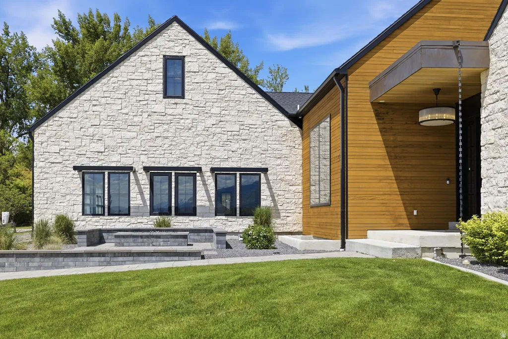 Stone and wood-clad exterior with a prominent gabled roofline and black-framed windows