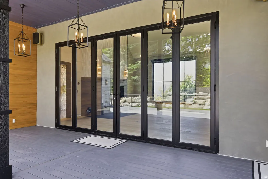 Exterior deck featuring gray composite decking and a purple-hued ceiling