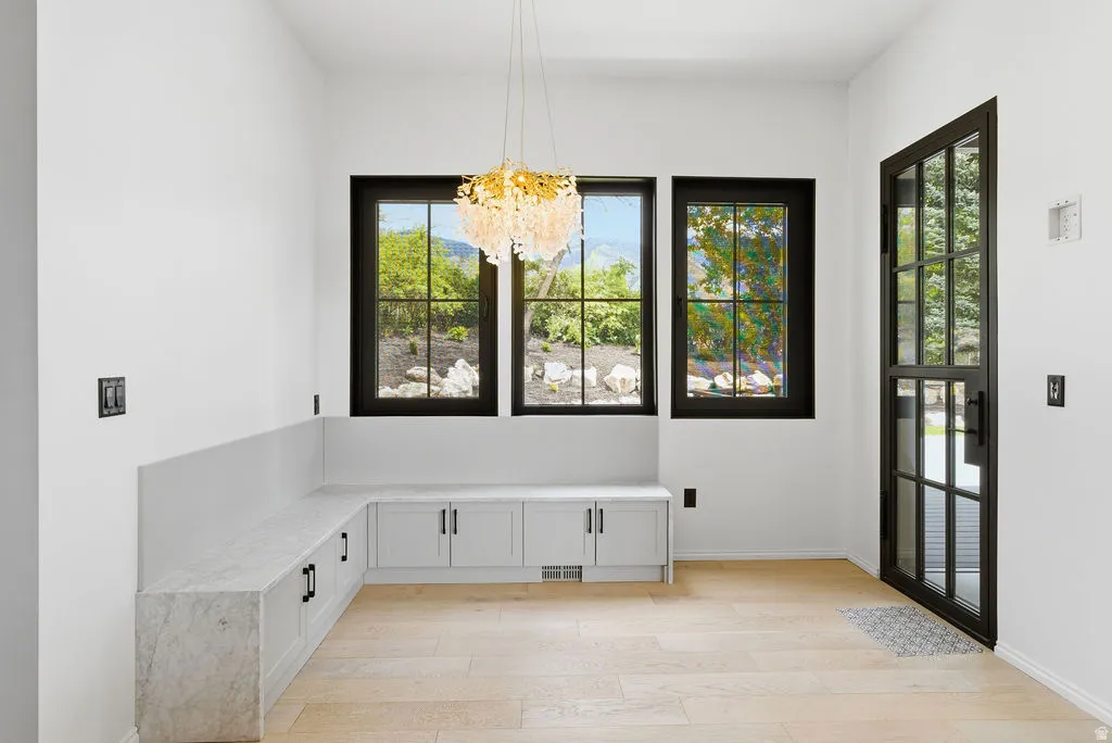 Entryway featuring light wood-finish flooring and a built-in L-shaped bench with a light-toned countertop