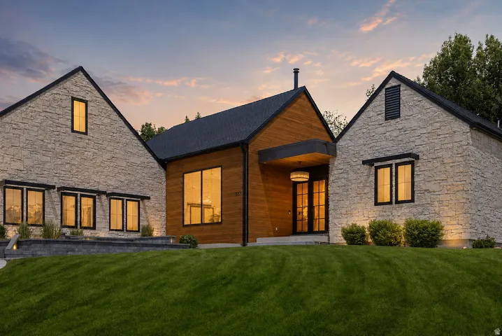 Exterior featuring stone veneer and vertical wood siding