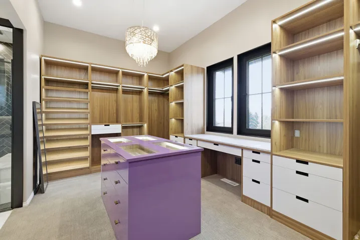 Custom closet system featuring natural wood-finish shelving and hanging rods