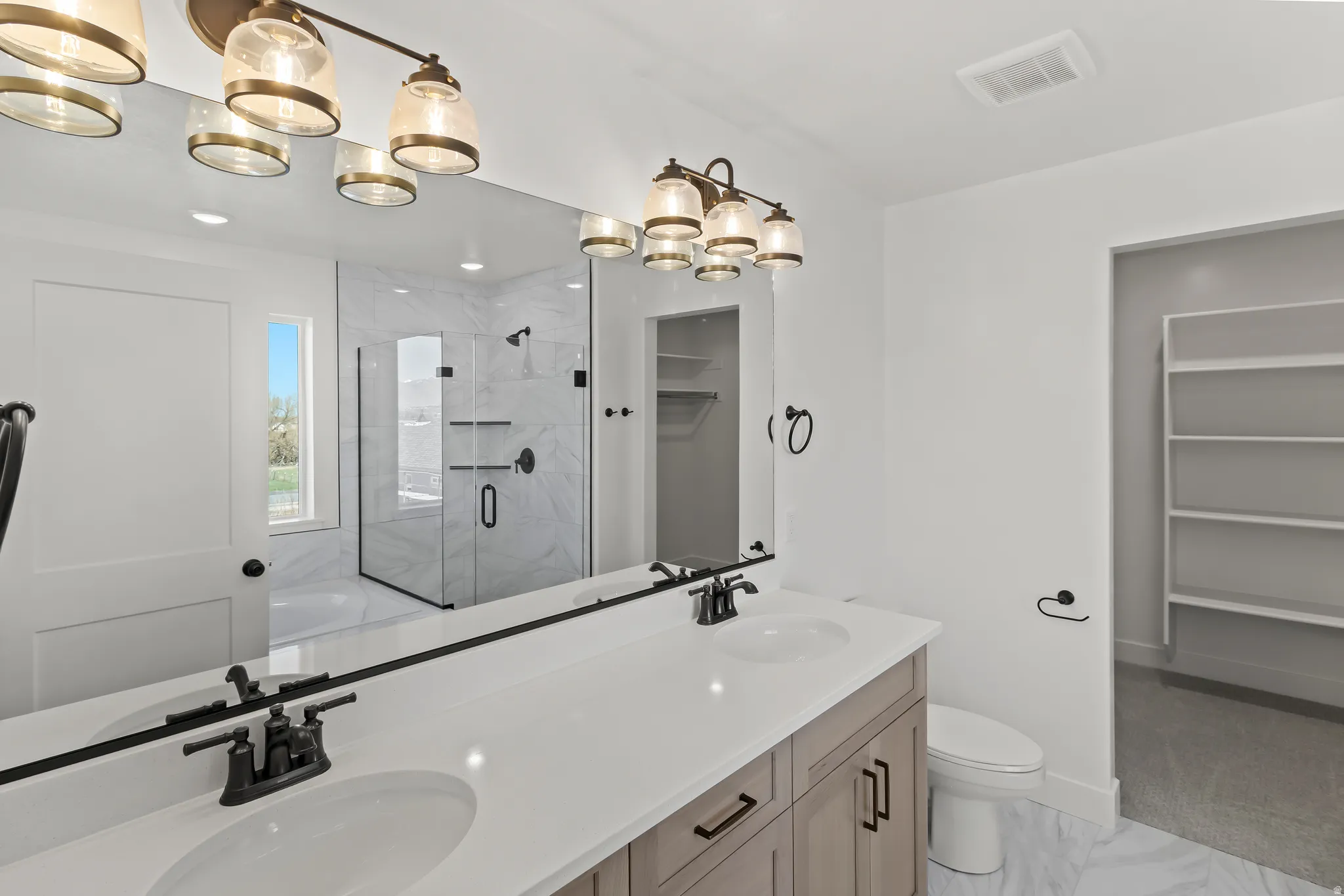 Dual vanity with undermount sinks and matte black fixtures
