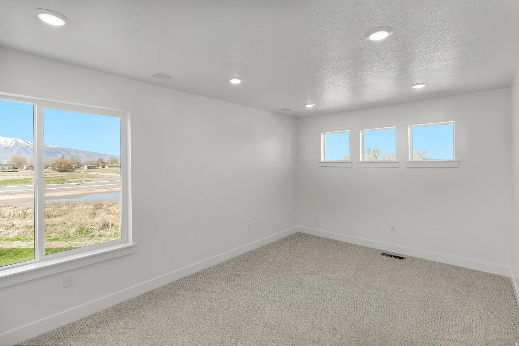 Bright room with a large picture window and three transom windows